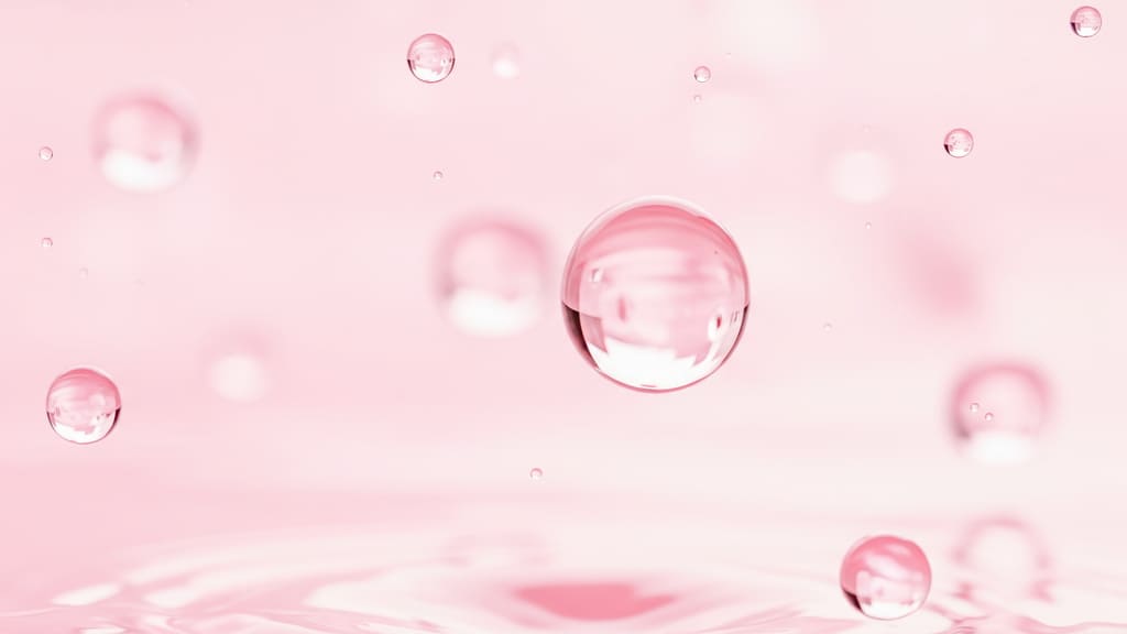コラーゲンをイメージしてピンクの球体が弾けている様子