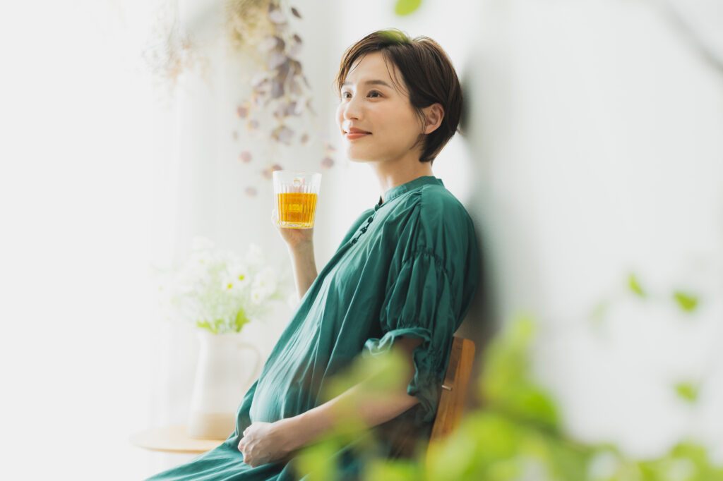 飲み物を持つ妊婦さん