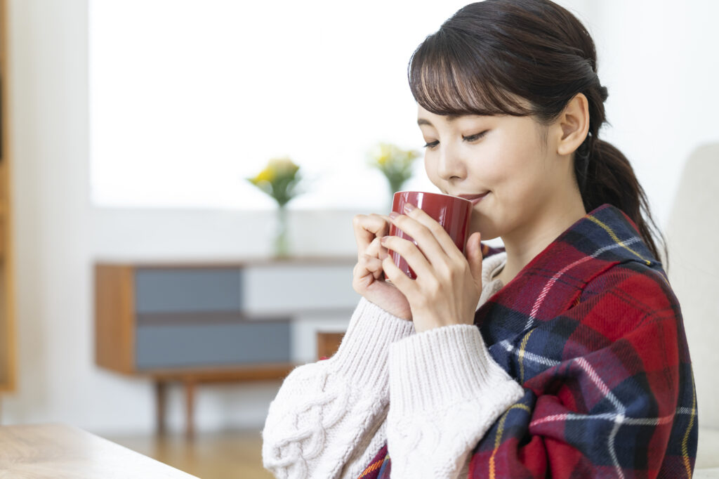 温かい飲み物を飲む女性